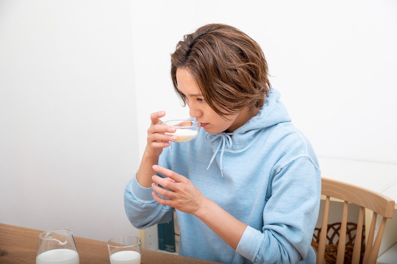 スキムミルク(脱脂粉乳)を手に取る食育インストラクターの和田明日香さん