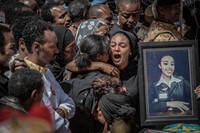 Relatives hold photographs of the victims at a mass funeral at the Holy Trinity Cathedral in Addis Ababa, Ethiopia Sunday, March 17, 2019. Thousands of Ethiopians have turned out to a mass funeral ceremony in the capital one week after the Ethiopian Airlines plane crash. Officials have begun delivering bags of earth to family members of the 157 victims of the crash instead of the remains of their loved ones because the identification process is going to take such a long time