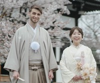 和装姿で笑顔を見せる2人。背景には京都の寺院と満開の桜／投稿主さん提供＝画像をトリミングしています