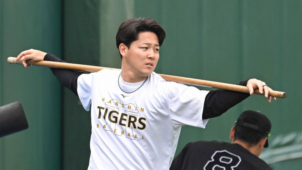 木棒を使ってストレッチする木下