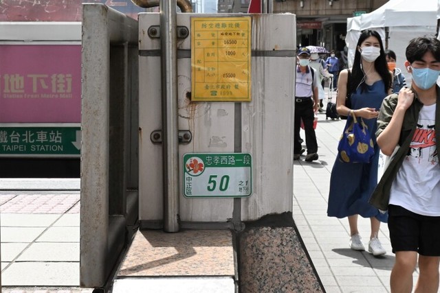 台北駅の地下街が、空襲時の防空壕になっていることを示す黄色の標識＝台北市、石田耕一郎撮影