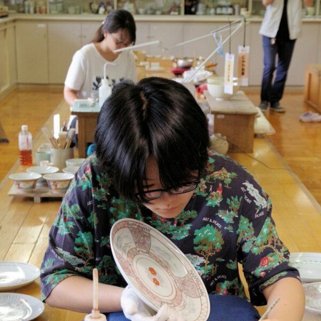 緻密な文様を皿に描く絵付デザイン科の訓練生