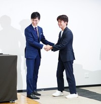 新代表に決まった奥村光貴氏（右）と握手を交わす石丸伸二氏
