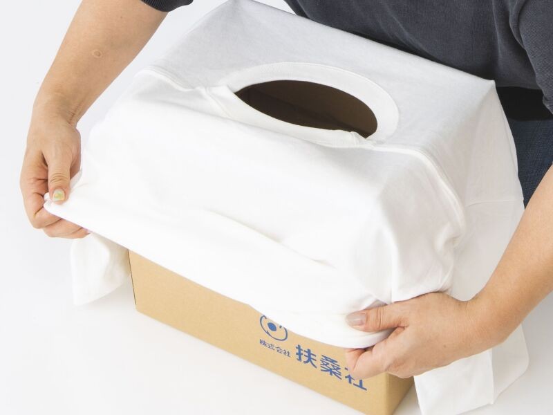 セットした段ボールにTシャツをかぶせる。猫が出入りしやすいよう首回りの位置を調整（扶桑社提供）