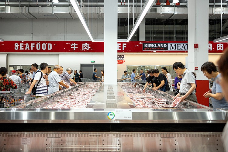 Customers shop for meat at Costco in Shanghai, Sept. 10, 2019. Chinese consumers, who have become more cautious over the past year, are now staging a broad retreat. They are buying fewer cars, smartphones and appliances, going to the movies less and taking fewer trips abroad. (Yuyang Liu/The New York Times)