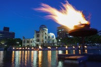 原爆ドーム脇を流れる元安川で8月5日夜、原爆犠牲者を慰霊するかがり火がともされた。火は平和記念公園の「平和の灯」から採火され、通行人らが祈りを捧げた＝2021年8月5日午後7時34分、広島市中区、田辺拓也撮影