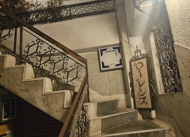 鉄格子の先。3階の店舗までの階段を見上げる（「旅人YAMA」さん提供）