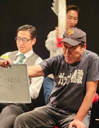 なべやかん（後方）主催のお笑いイベントに出演している芸人・小堀敏夫（右）＝都内