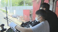 路面電車の運転を体験する小学生