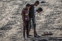 Onlookers inspect debris at Bishoftu, or Debre Zeit, outside Addis Ababa, Ethiopia, Monday, March 11, 2019, where Ethiopia Airlines Flight 302 crashed Sunday. Investigators are trying to determine the cause of a deadly crash involving a new aircraft model touted for its environmentally friendly engine that is used by many airlines worldwide.