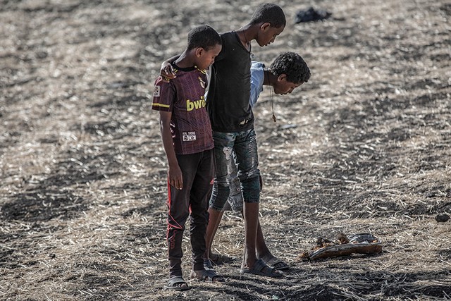 Onlookers inspect debris at Bishoftu, or Debre Zeit, outside Addis Ababa, Ethiopia, Monday, March 11, 2019, where Ethiopia Airlines Flight 302 crashed Sunday. Investigators are trying to determine the cause of a deadly crash involving a new aircraft model touted for its environmentally friendly engine that is used by many airlines worldwide.