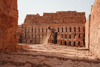 旧式のれんが工場で、赤茶色の粉じんが舞う中、男性が焼き上がったれんがを取り出していた=2024年5月3日、ダッカ郊外、荒ちひろ撮影