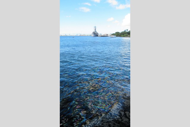 米戦艦アリゾナから流れ出る油。遠くに見えるのは米戦艦ミズーリ=2025年10月、ハワイ