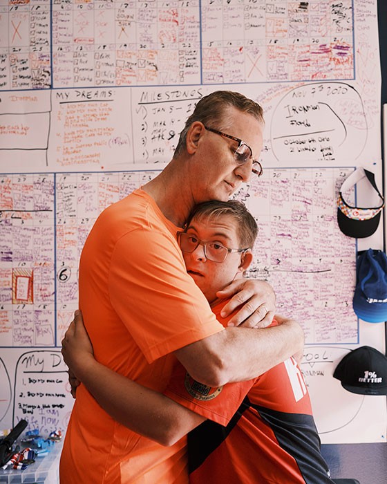 Chris Nikic with his father, Nik, at their home in Maitland, Fla., Nov. 14, 2020. Nikic, 21, became the first person with Down syndrome to conquer the grueling Ironman endurance race, offering lessons in perseverance and hope. (Zack Wittman/The New York Times)