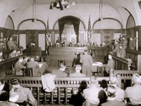 BC級戦犯の審理が行われた「横浜法廷」。星条旗2流が掲げられた正面が判事席、その下が被告席、左右に検事席と弁護士席。横浜裁判はアメリカによるBC級戦犯に対する軍事法廷で、連合国によるA級戦犯の極東国際軍事裁判（東京裁判）とは別に1949年10月19日まで行われ約1000人が死刑を含む判決を受けた