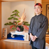 名誉総裁賞を受け、さらなる研さんを誓う土江徹さん。中央が受賞作の「深山彩秋」＝島根県出雲市斐川町、福泉堂