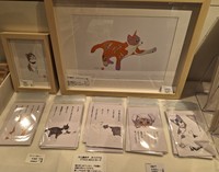 「新宿にゃあ博」で販売されている川上麻衣子が手がけた絵画やポストカード＝都内の小田急百貨店新宿店