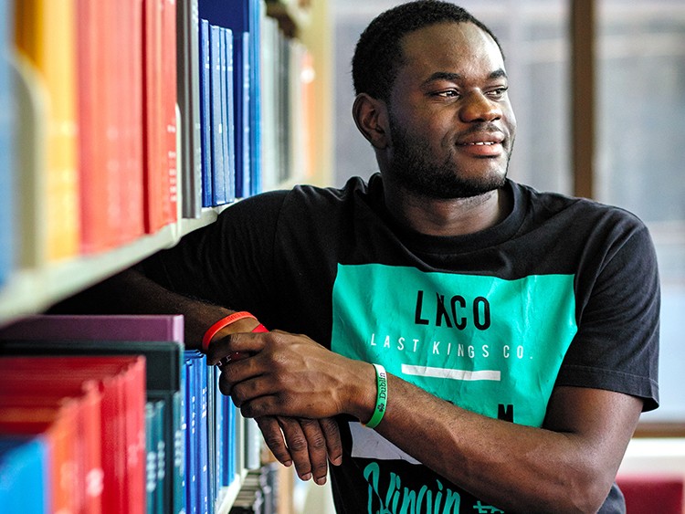 Naf Luyeye Makabu, born in the Republic of Congo, on Florida International University's campus in Miami, May 29, 2019. A community college program, Educate Tomorrow, helps students like Makabu who have faced instability at home study overseas. Makabu got to take a literature course in Britain and visit Windsor Castle. (Scott McIntyre/The New York Times)