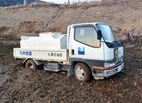 沼地にハマってしまい、動けなくなった丸野石油店の配達用トラック。ちなみに「九州石油」とあるのはお下がりのためで、同店はENEOSだそうです（提供）