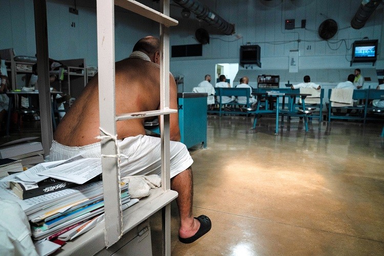 Inmates cooling off near industrial fans inside Lopez State Jail, a facility that lacks air conditioning, in Edinburg, Texas, Aug. 19, 2022. Texas is having its second-hottest summer on record, yet most state prisons and jails have no air conditioning. (Verónica G. Cárdenas/The New York Times)