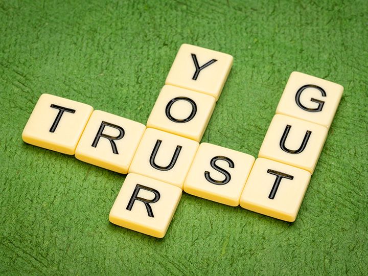 TRUST YOUR GUT crossword in letter tiles against textured handmade paper［original photo: MarekPhotoDesign.com – stock.adobe.com］