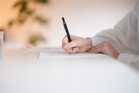 手書きのメモを書く女性　※この画像はイメージです（maru54/adobe.stock）