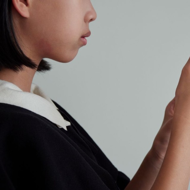 スマートフォンを手にする少女　※この画像はイメージです（zheng giang/stock.adobe.com）