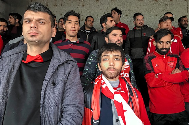 Zeinab, a 22-year-old girl. It seems strange to men that a girl has disguised herself as men to enter the stadium.As a female photographer, I'm not permitted to take my camera to the stadium. Therefore, I had to pass myself of as a boy and use my iPhone to take this shot.