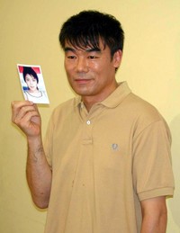 中江里香の写真を片手に結婚会見を行う村田雄浩=2006年