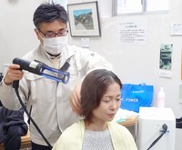 【洗髪の様子】この状態で髪は濡れるのに衣服は濡れない（画像提供：株式会社ティ.アイ.プロス）