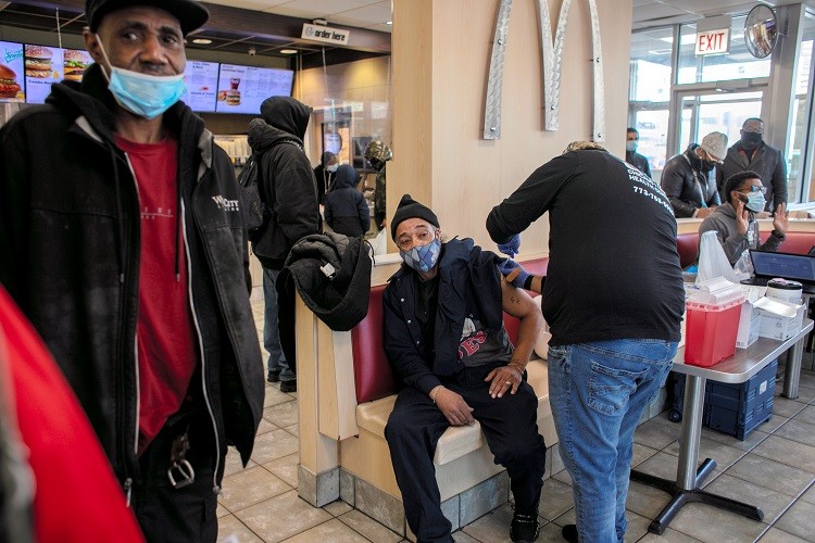 A man receives a booster shot for the coronavirus disease (COVID-19) at a McDonald's, as the Omicron coronavirus variant spreads through the country, in Chicago, Illinois, U.S., December 21, 2021. REUTERS/Jim Vondruska