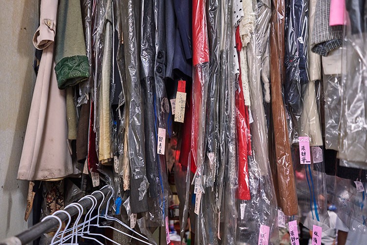 A collection of clothes abandoned by customers hangs in a corner of  Wansho Laundry in Taichung, Taiwan, July 23, 2020. The octogenarian owners of the laundry shop in central Taiwan have become Instagram stars for posing in garments left behind. (An Rong Xu/The New York Times)