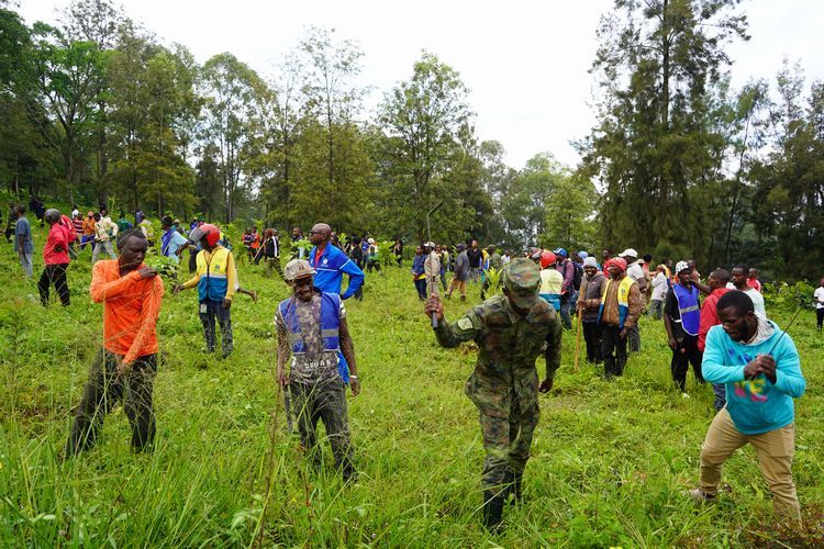 ウムガンダの日、虐殺記念館の敷地で草刈りをする住民ら