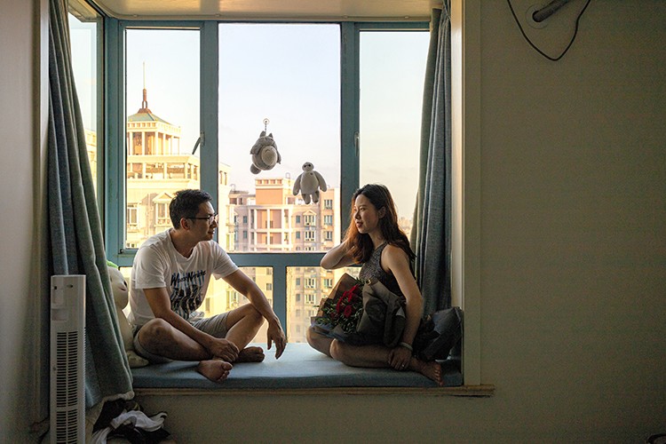George Gao and his fiancée Mengjie Wu, who are considering postponing their wedding and foregoing a Tiffany's ring in favor of something less expensive, in Shanghai, Sept. 15, 2019. Chinese consumers, who have become more cautious over the past year, are now staging a broad retreat. They are buying fewer cars, smartphones and appliances, going to the movies less and taking fewer trips abroad. (Yuyang Liu/The New York Times)