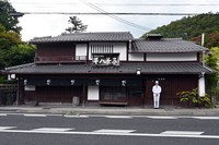 調理場がある母屋の前に立つ園部さん
