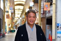 安立商店街に立つ遊喬さん